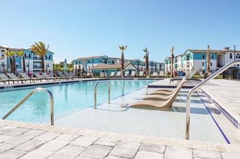 a swimming pool with a slide in front of some apartments